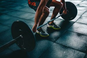 Weight lifter and barbell with knee pain