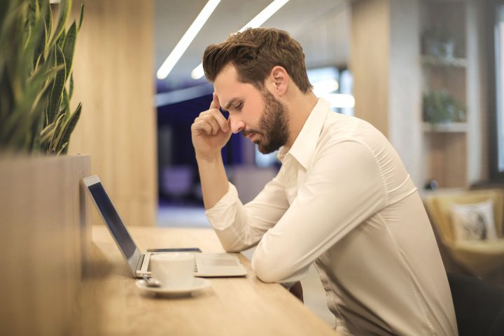 Man with poor posture at table at risk of back pain