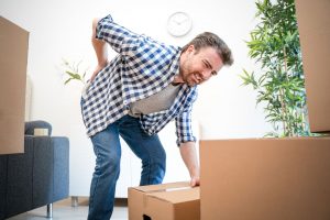 Man hurts back bending and lifting
