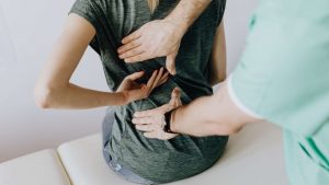 Brighton chiropractor treating woman with back pain
